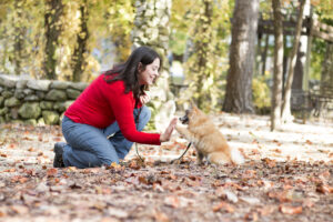 Becca giving a high five to Percy the Pomeranian